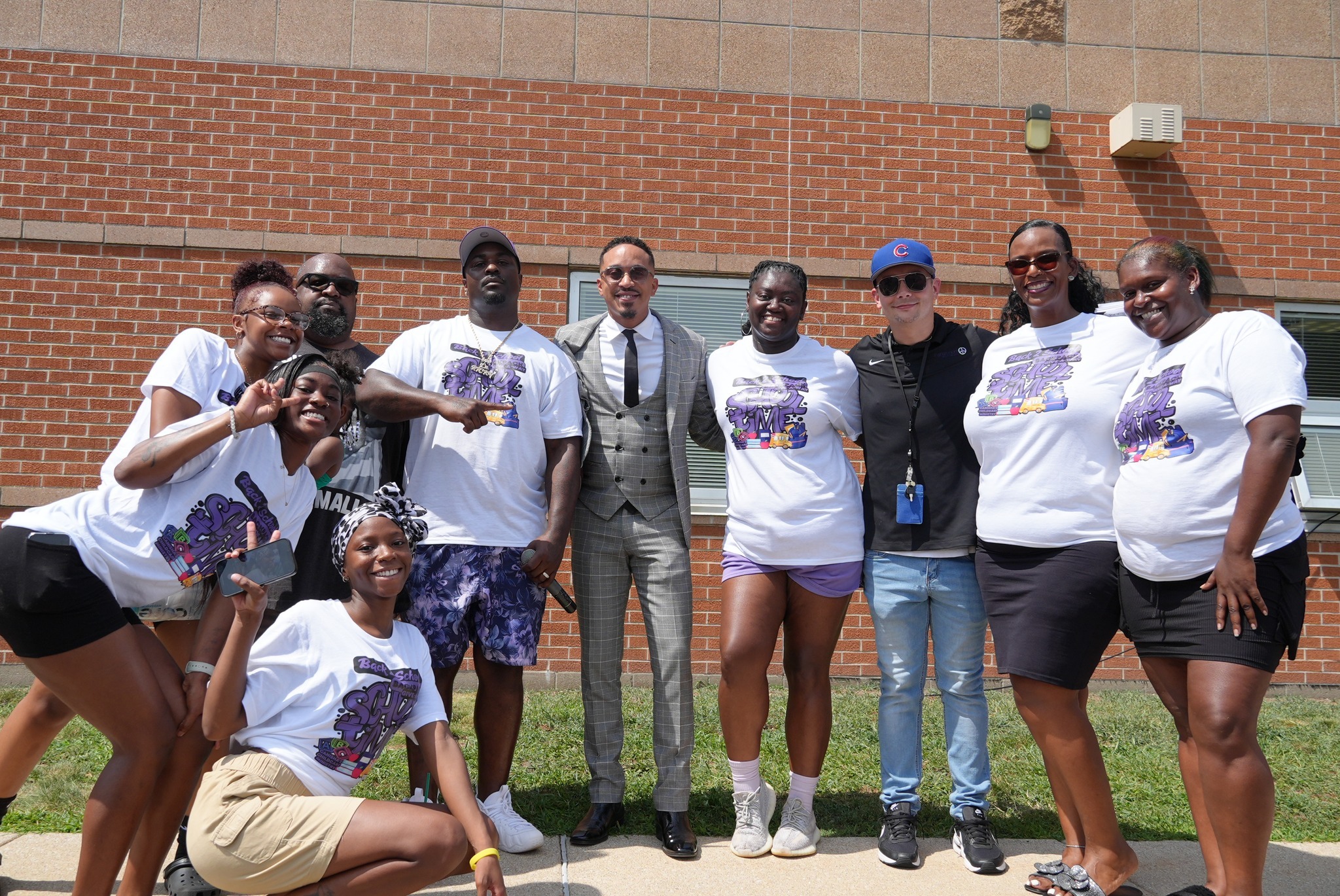 Paramount South Bend staff and community members pose together during a back-to-school backpack giveaway.