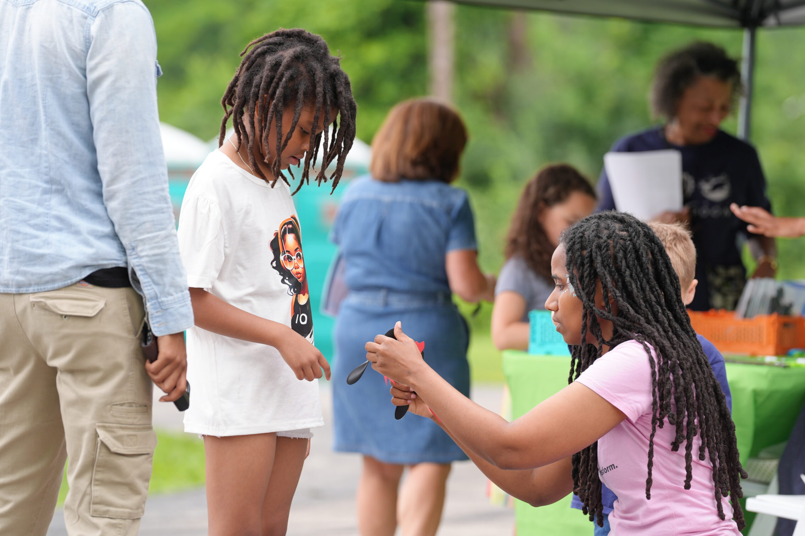 Student participates in a hands-on activity with an instructor at the Girls IN STEM Academy STEM Fest.
