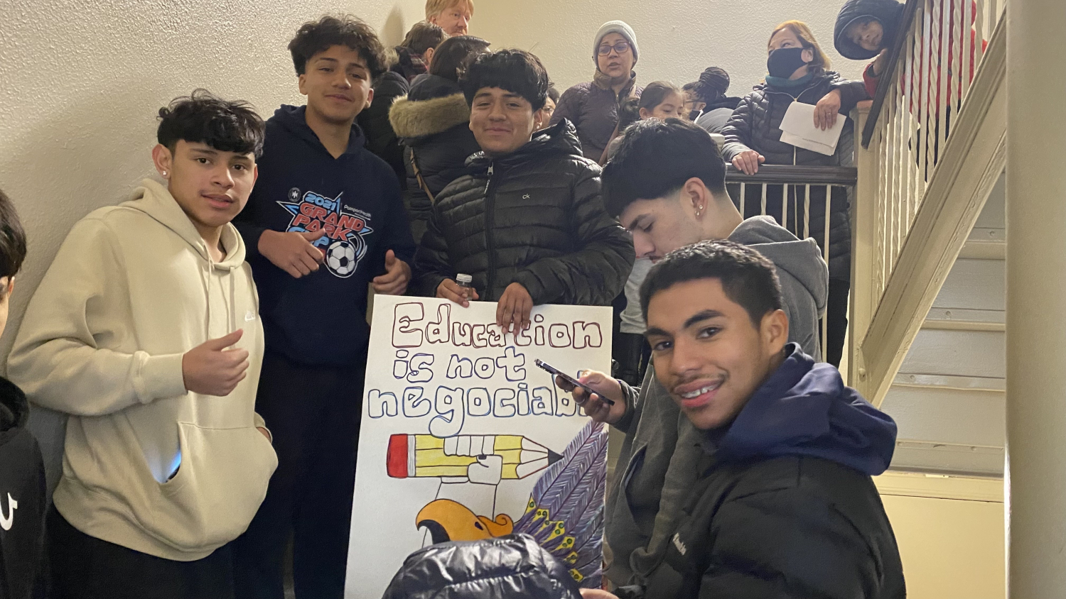 img-4574 Students gather with an “Education is not negotiable” poster during a school event.