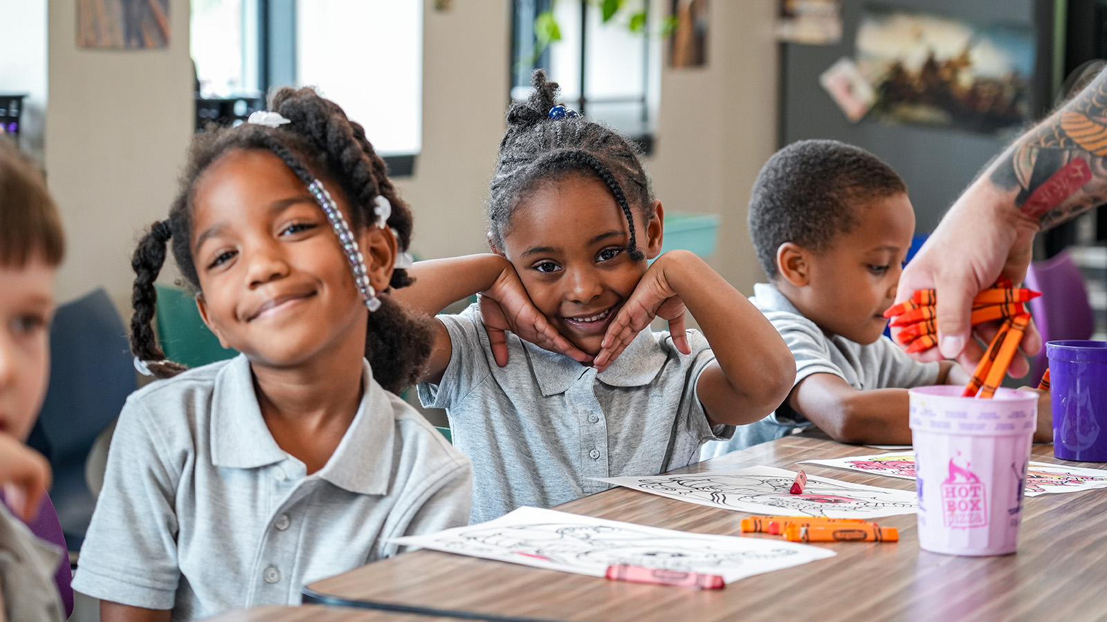 cottage-home-parent-center-hero Smiling Paramount Cottage Home students sitting together at a classroom table during a coloring activity