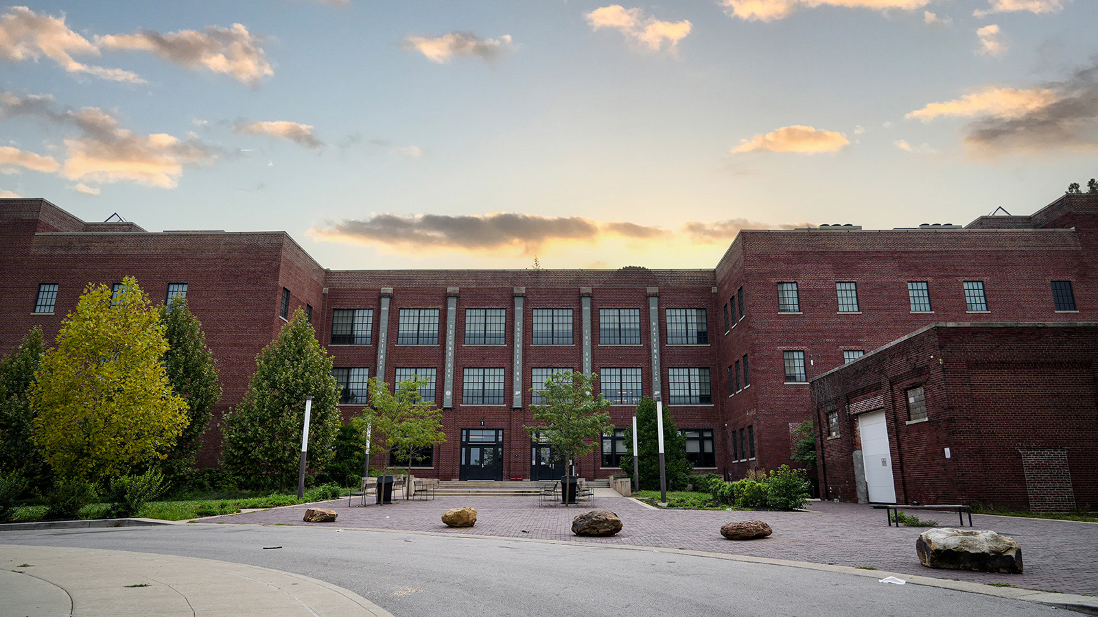 englewood-tour-hero Exterior of Paramount Englewood school in Indianapolis featuring its historic brick building and courtyard at sunset