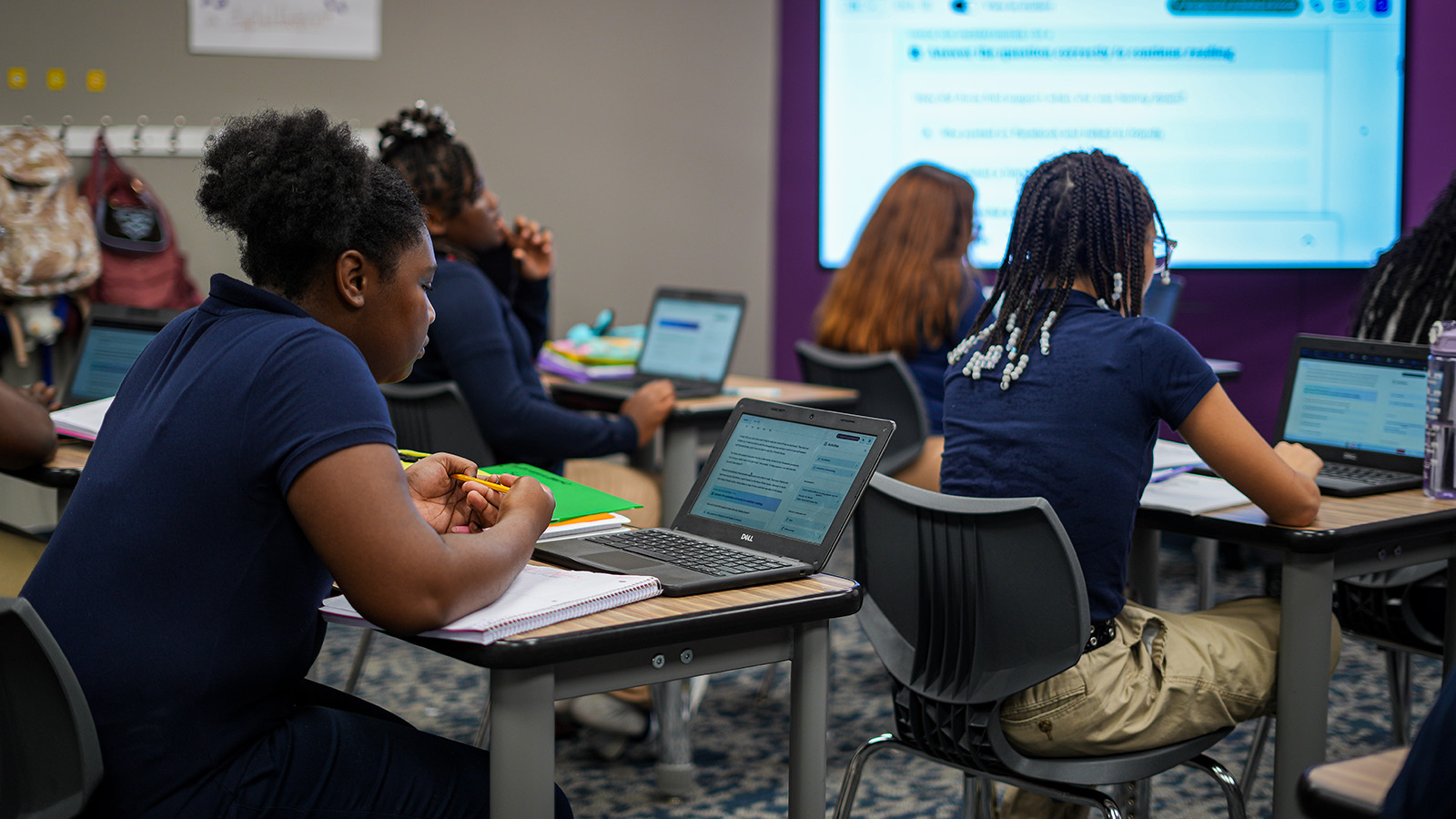 Girls IN STEM Academy students working on laptops and completing assignments during a classroom lesson