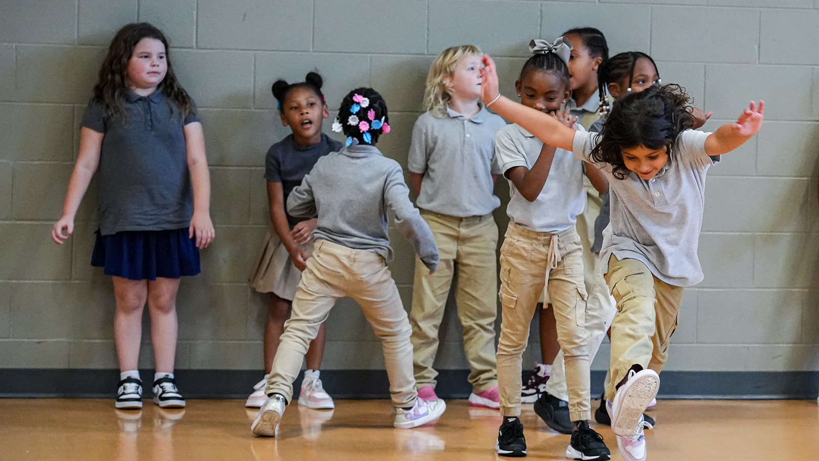 Paramount students playing and dancing together in the school gym