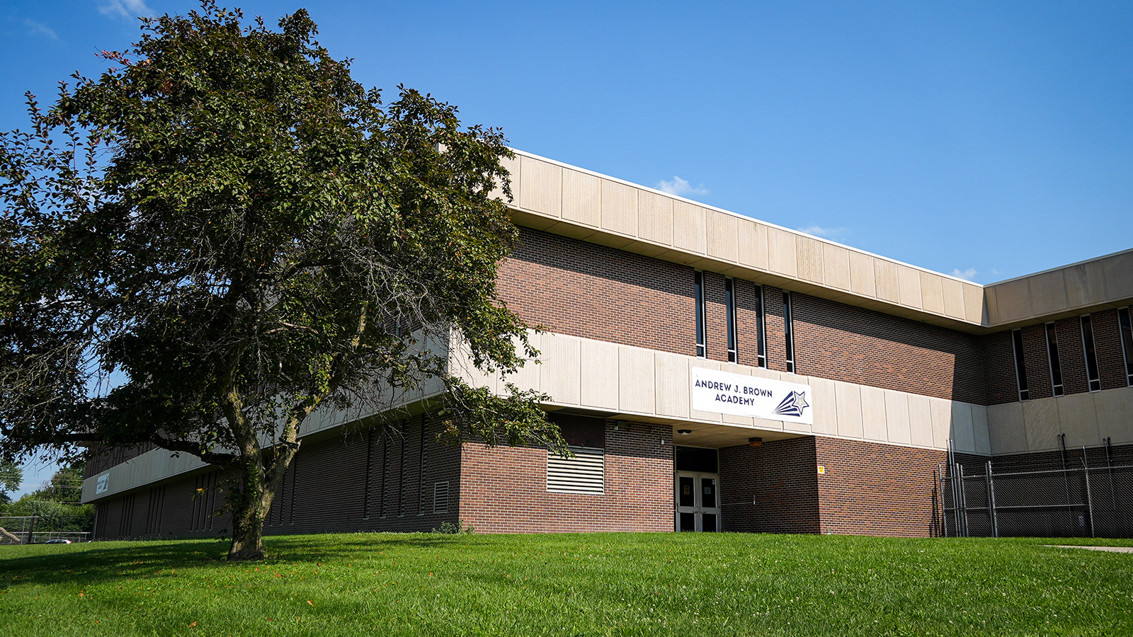 Exterior of Andrew J. Brown Academy in Indianapolis featuring the brick school building, main entrance, and school signage