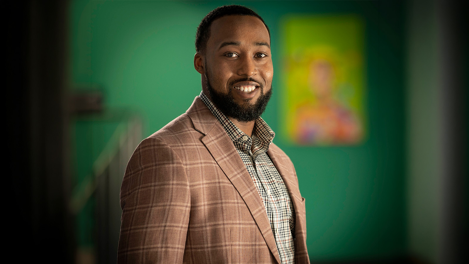 Paramount Brookside School Director Dexter Taylor smiling for a professional portrait inside the school
