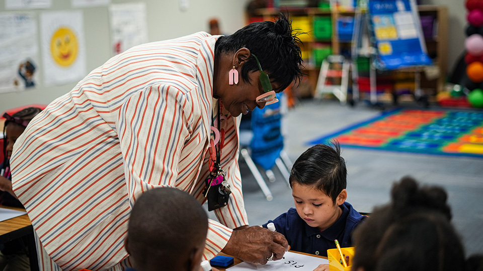 Paramount teacher helping a student with classroom work