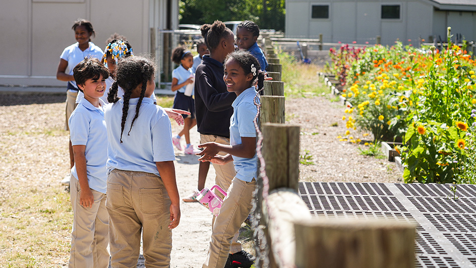 cottage-home-features-4 Paramount Cottage Home students talking and exploring the school garden together