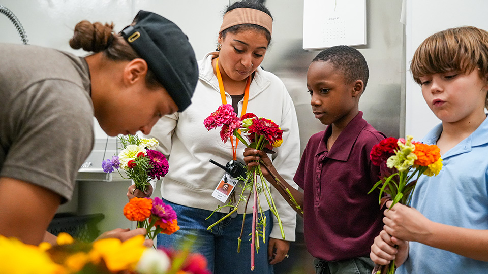 cottage-home-home-4-1 Paramount Cottage Home students arranging colorful flower bouquets with guidance from school staff