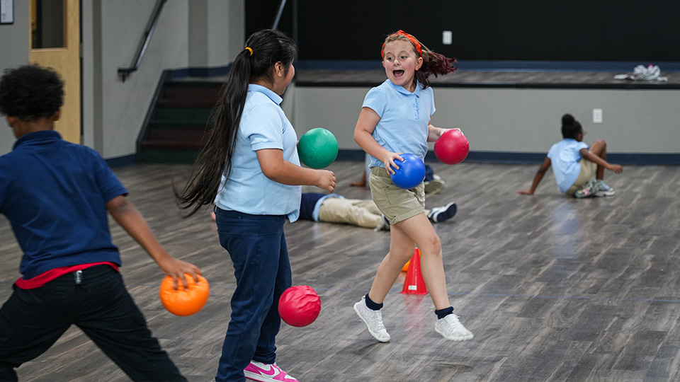 cottage-home-home-4-5 Paramount Cottage Home students playing with colorful balls during an indoor physical education activity