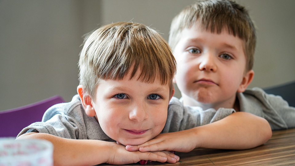 cottage-home-parent-center-2 Two young Paramount Cottage Home students posing together at a classroom table