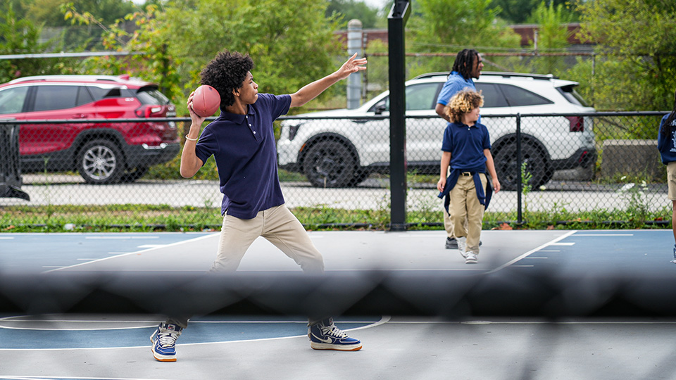 Paramount Englewood student preparing to throw a ball during an outdoor physical education activity