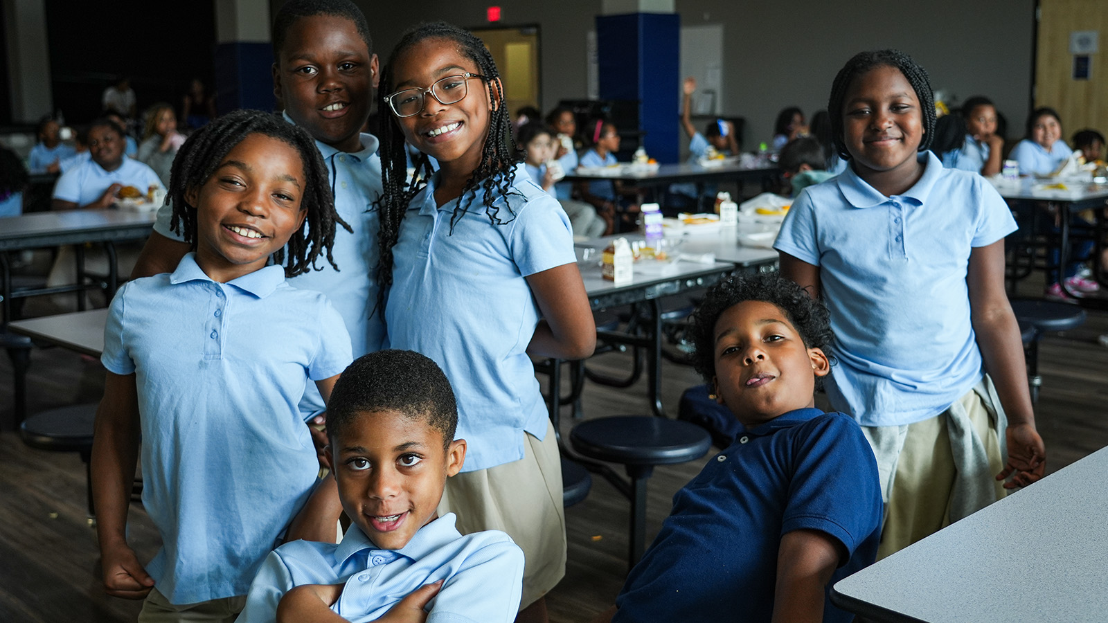 Group of Paramount students smiling together in the school cafeteria