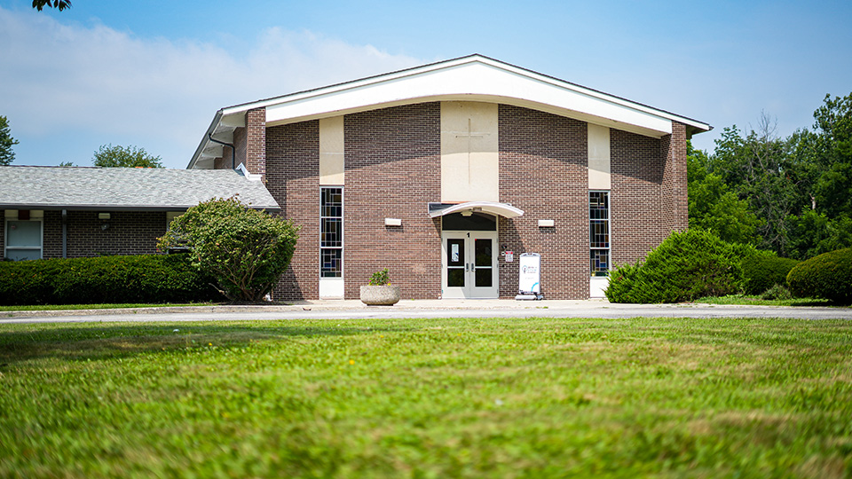 Exterior of Girls IN STEM Academy in Indianapolis featuring the brick school building, main entrance, and front lawn