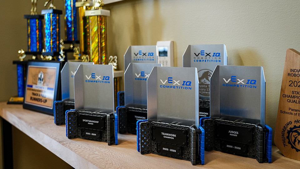 Paramount Lafayette robotics competition trophies and awards displayed on a shelf, celebrating student achievements in VEX IQ robotics