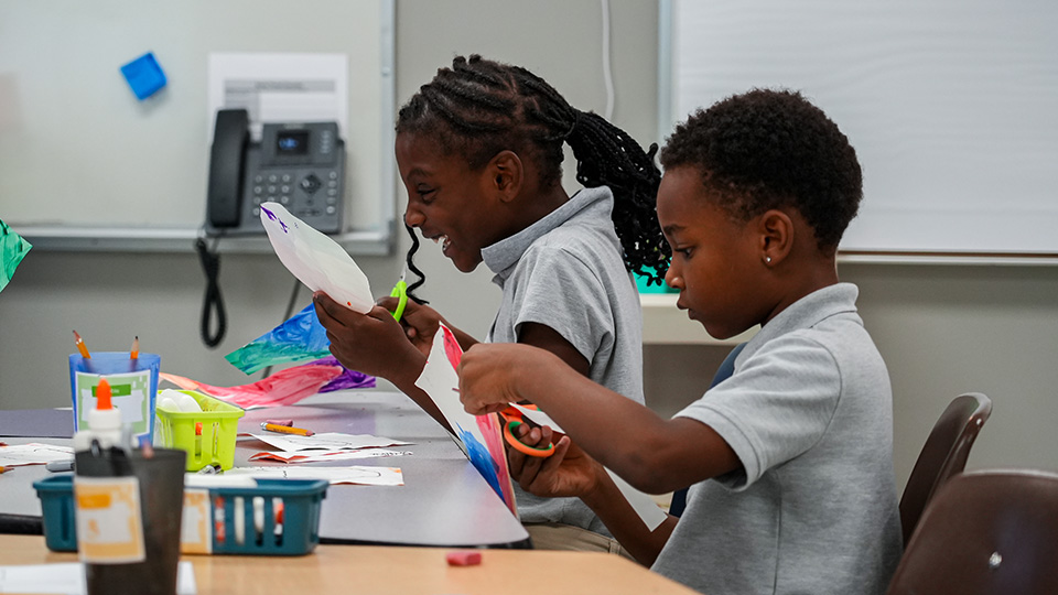 Paramount Lafayette students cutting and decorating colorful paper during a hands-on classroom arts and crafts activity