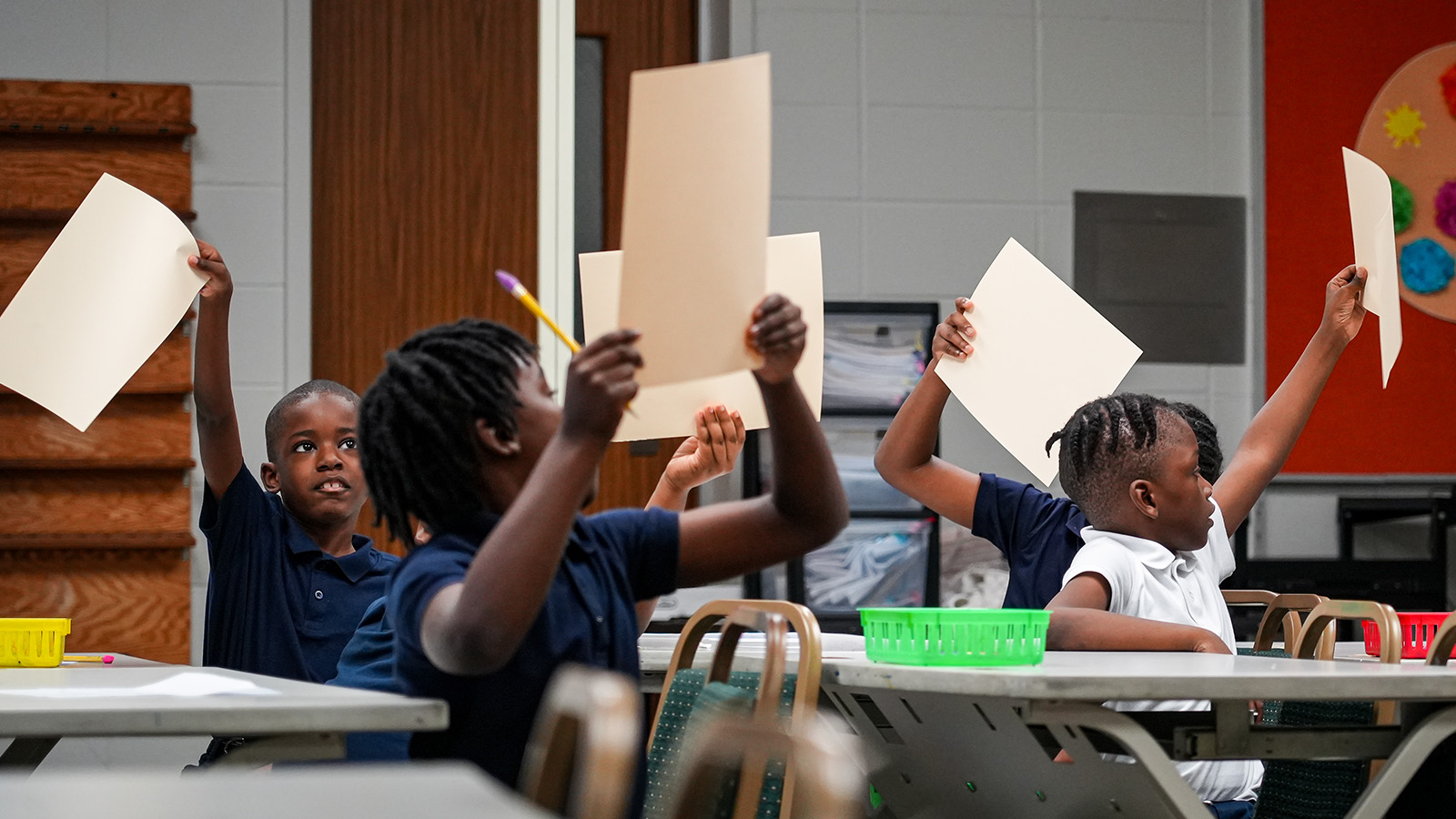 mission-and-results-hero Paramount students raising their papers during an interactive classroom activity