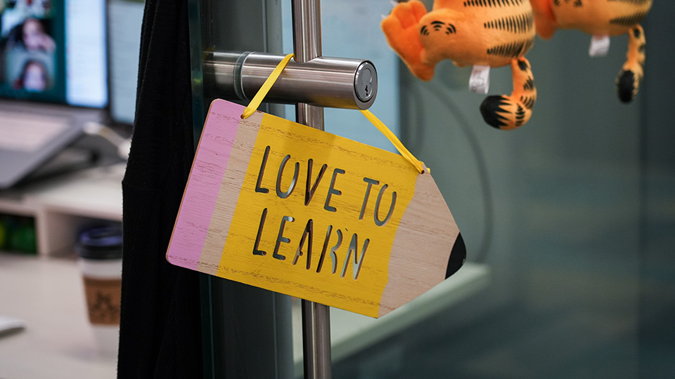 Colorful "Love to Learn" sign hanging on a classroom door at Paramount Online Academy