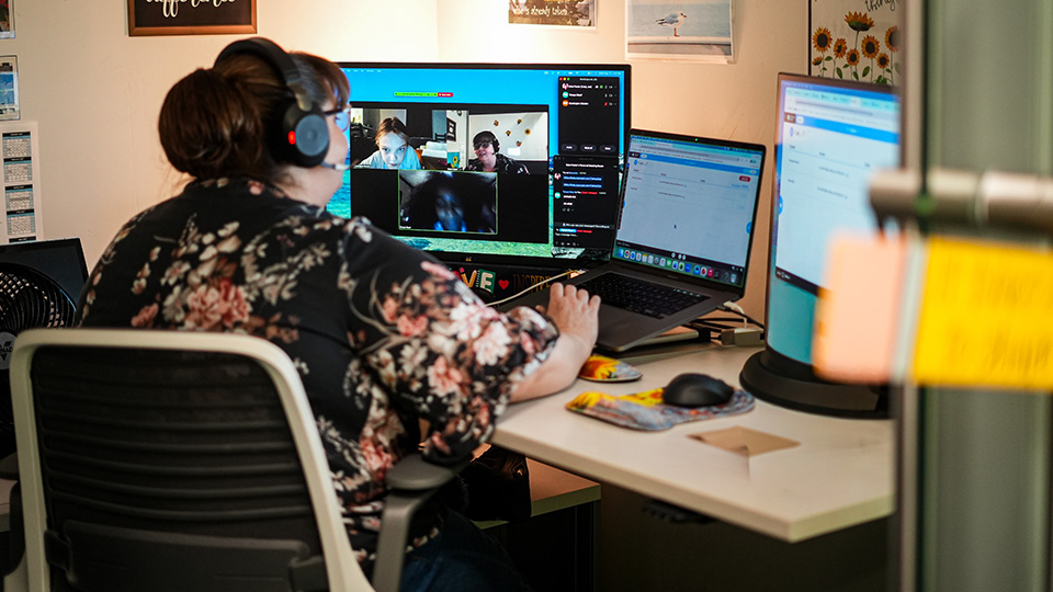 Paramount Online Academy teacher wearing a headset while leading a virtual classroom lesson with students through video conferencing