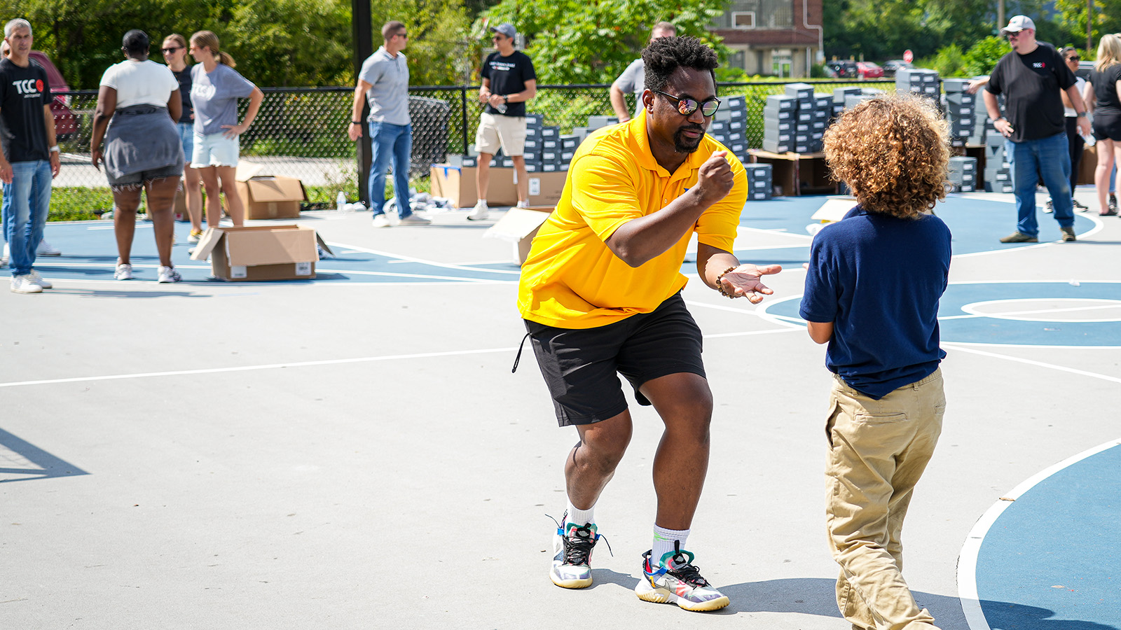 Paramount community partner interacting with a student during an outdoor school event