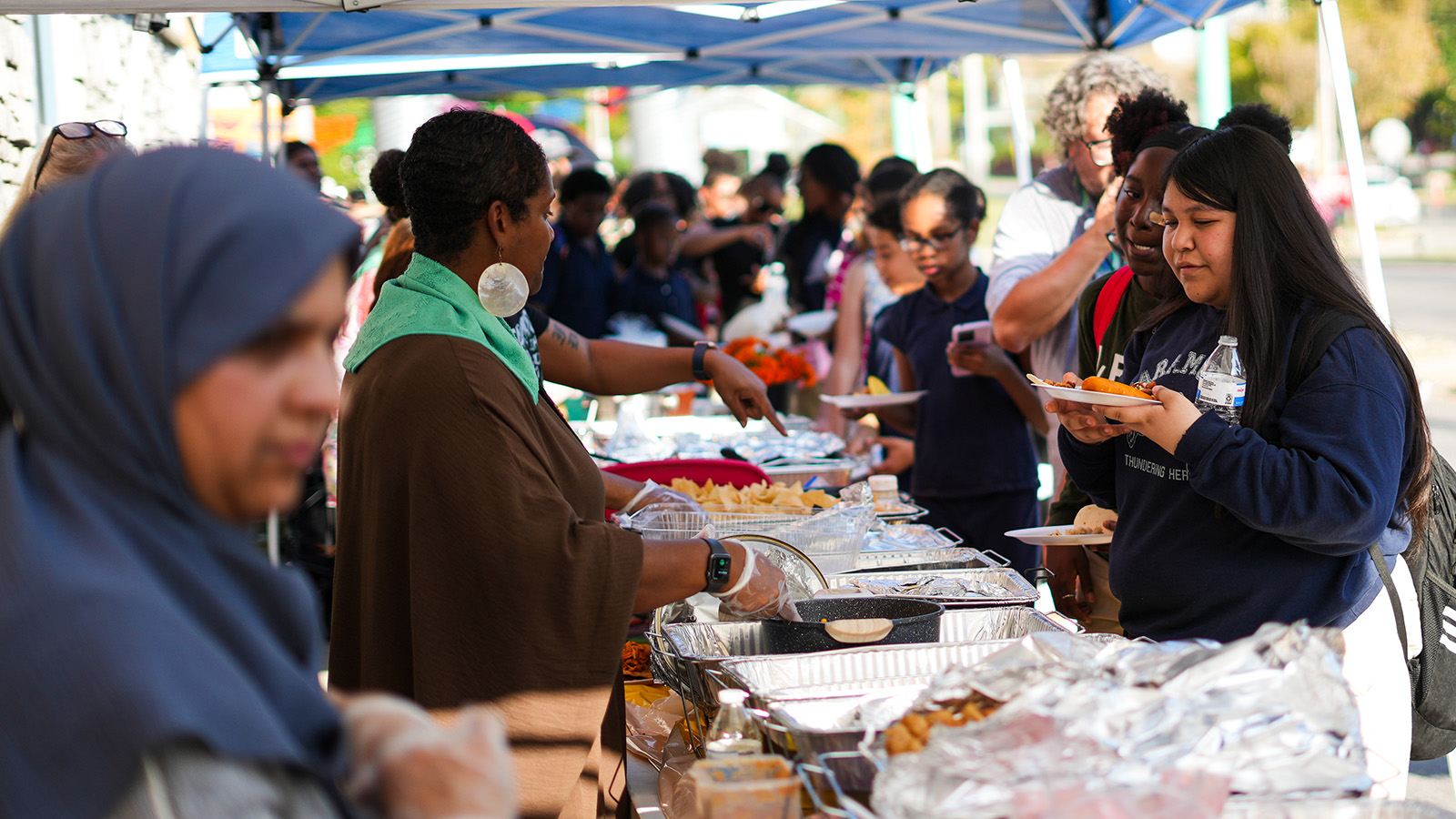 school-calendars-hero Paramount students and families enjoying food together at an outdoor school community event