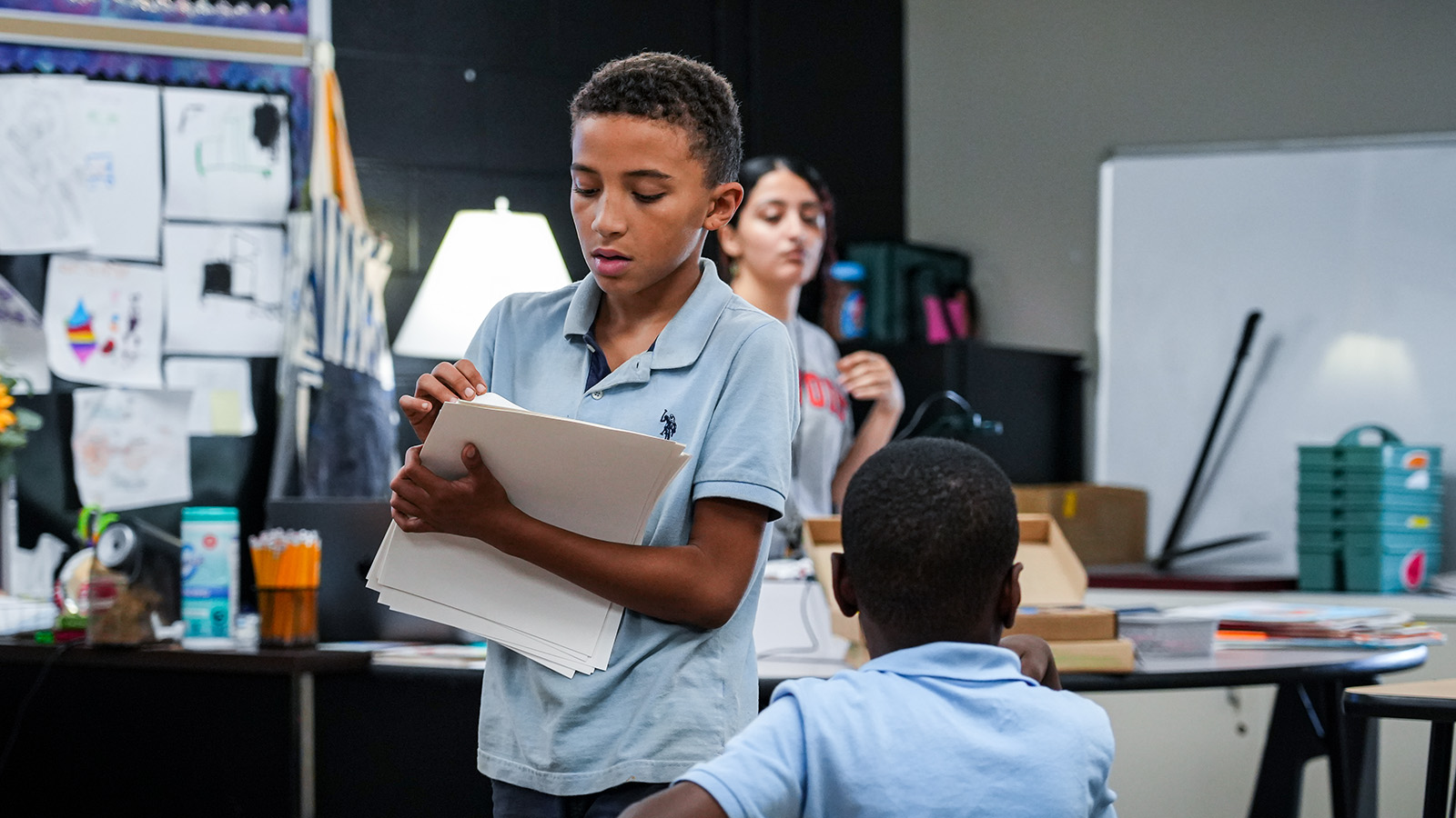 Paramount South Bend student reviewing worksheets while participating in a classroom activity with classmates
