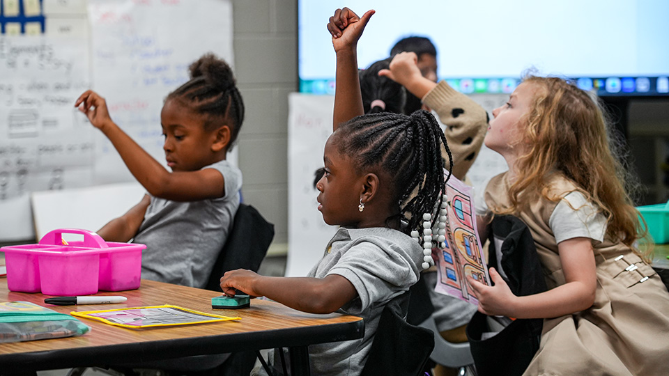 south-bend-parent-center-2 Paramount South Bend students raising their hands and participating in an interactive classroom lesson